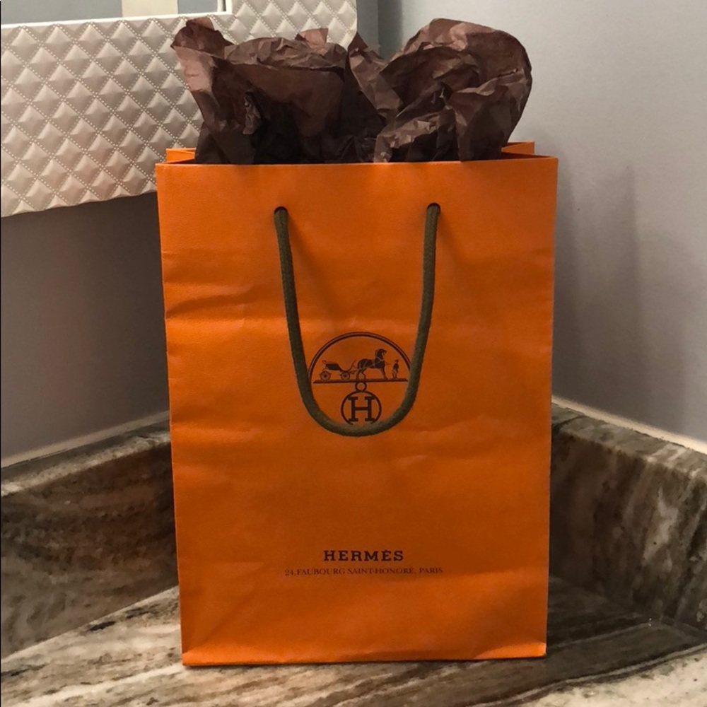 Hermès shopping bag, ribbon, and look book